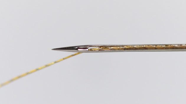 A #75/11 embroidery needle is a tight fit for metallic thread