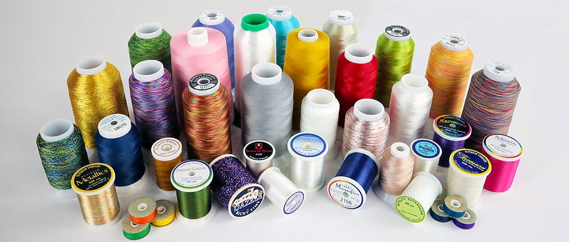 spools of thread, a row of spools of thread and a spool of thread