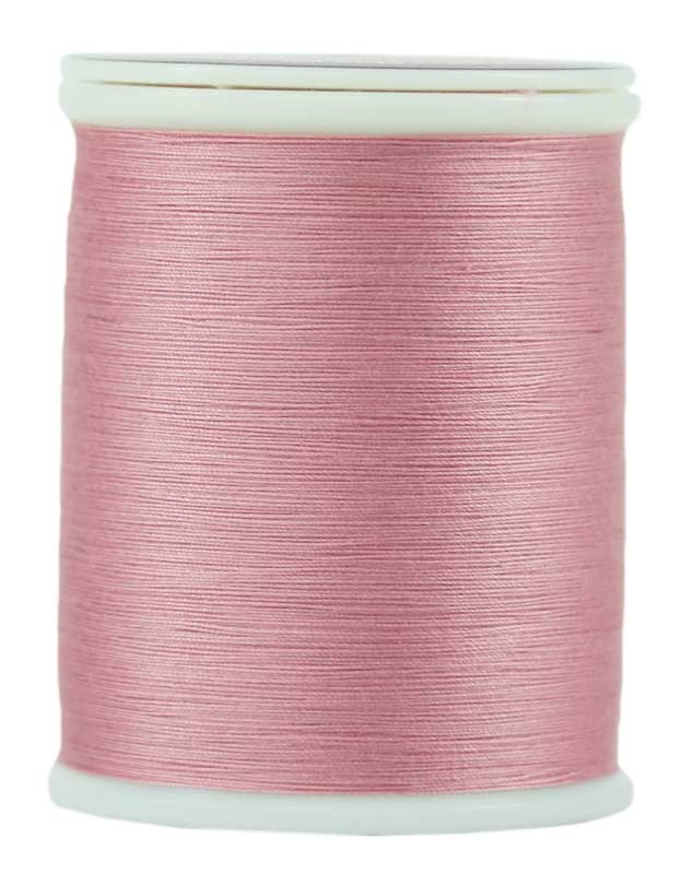 Premium Photo  A spool of pink thread a needle and a thimble on a